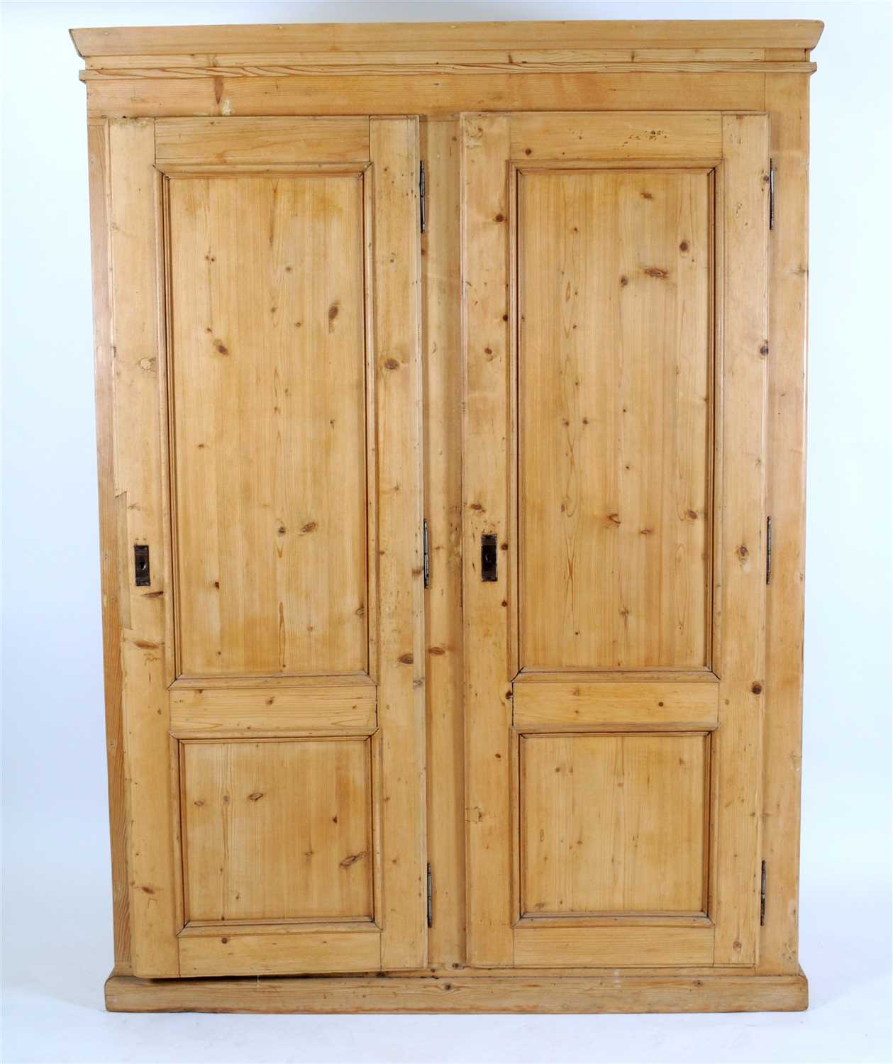 Lot 671 - A large pale scrubbed pine double wardrobe