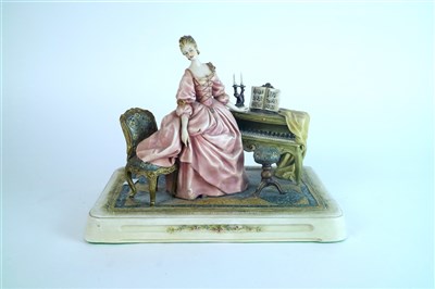 Lot 420 - A Capodimonte porcelain figure of a female pianist