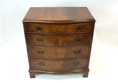 Lot 1017 - A mahogany veneered serpentine chest of four drawers