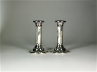 Lot 20 - A pair of silver mounted candlesticks