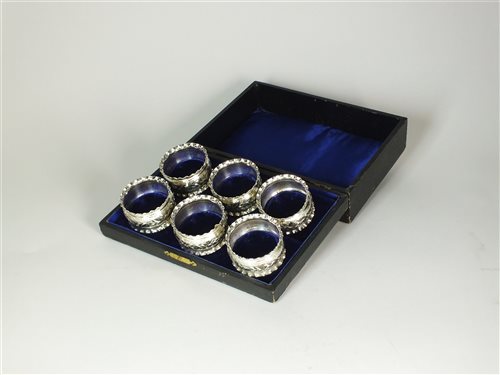 Lot 120 - A cased set of six silver napkin rings