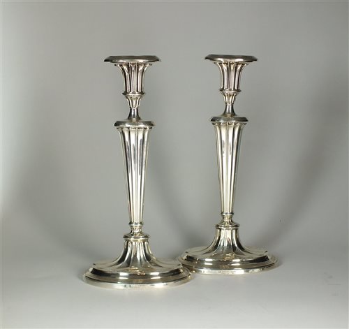Lot 106 - A pair of silver mounted candlesticks