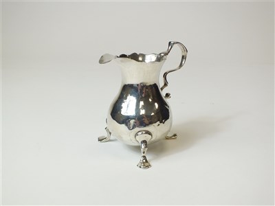 Lot 261 - A George II silver cream jug