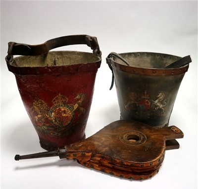 Lot 681 - Two British 19th century studded and painted leather fire buckets and a pair of elm fire bellows