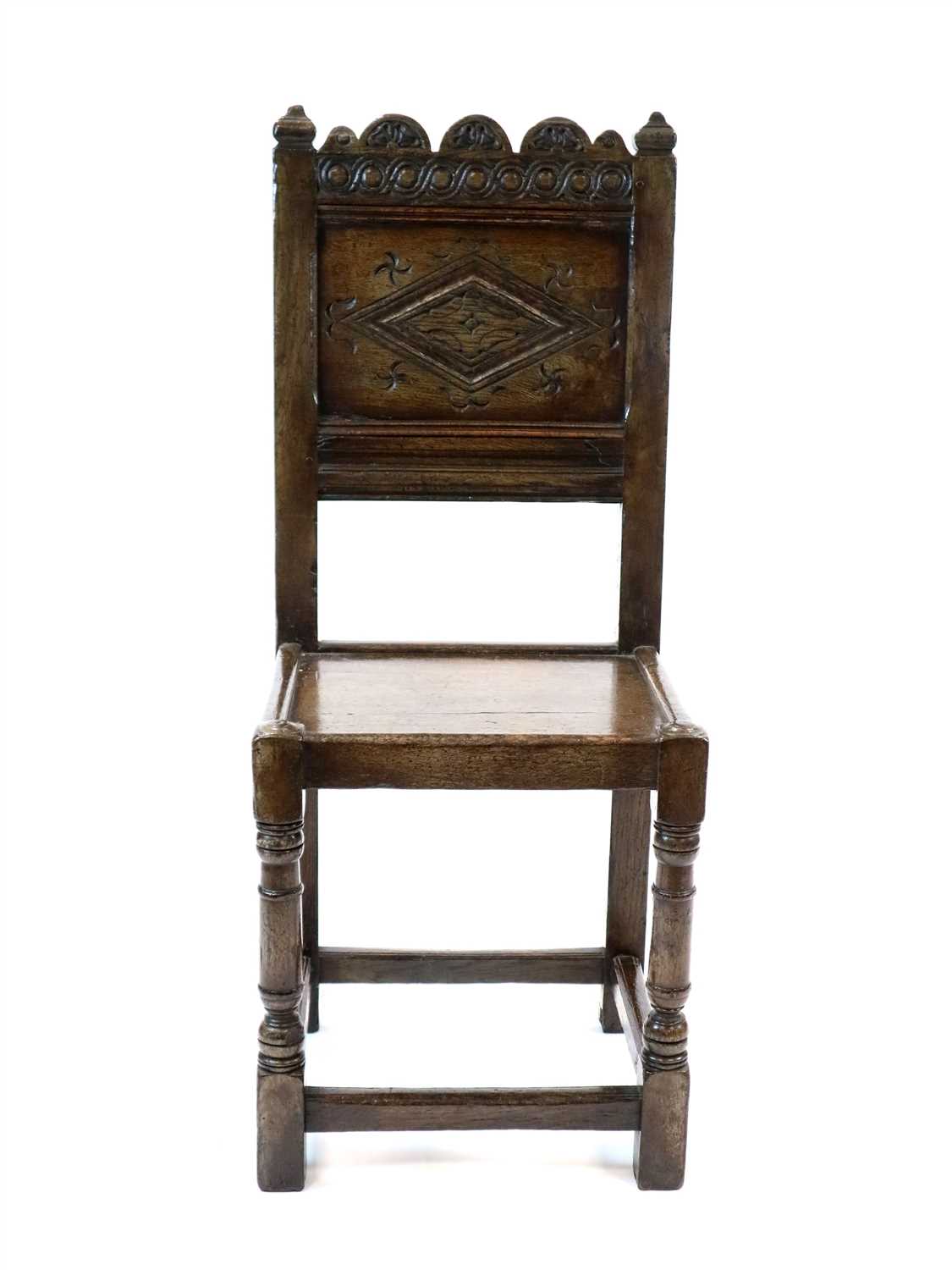 Lot 485 - An 18th century style carved oak panel back chair