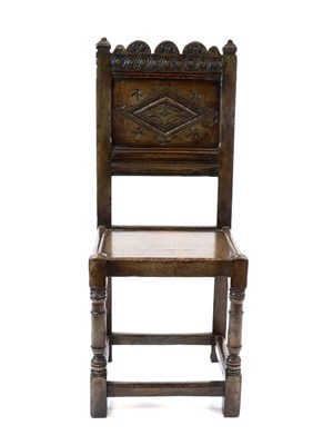 Lot 485 - An 18th century style carved oak panel back chair