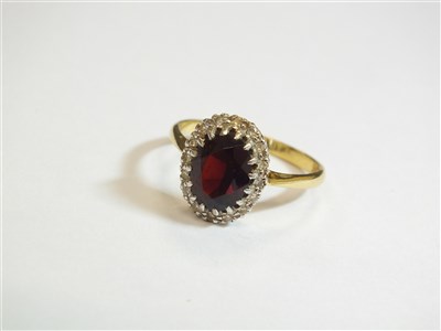 Lot 16 - A garnet and diamond cluster ring