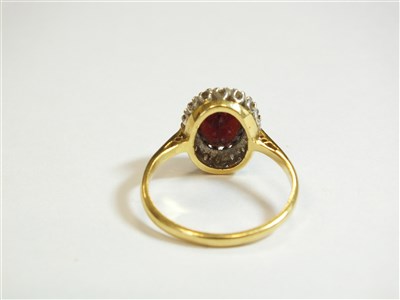 Lot 16 - A garnet and diamond cluster ring