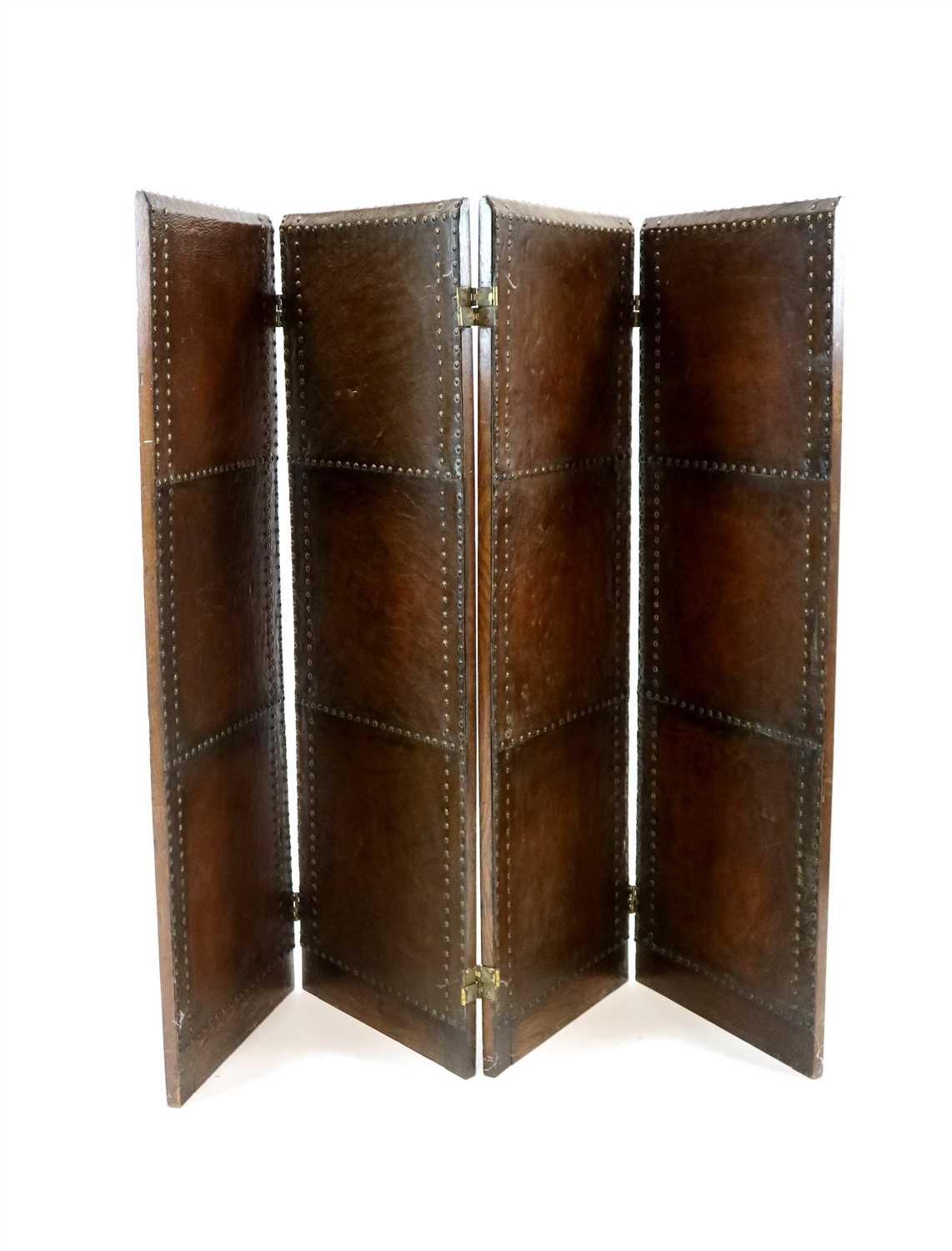 Lot 505 - An early 20th century studded leather oak framed four sectional screen / room divider