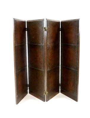 Lot 505 - An early 20th century studded leather oak framed four sectional screen / room divider