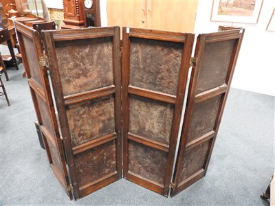 Lot 505 - An early 20th century studded leather oak framed four sectional screen / room divider