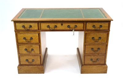 Lot 897 - An Edwardian style pale oak pedestal desk, modern