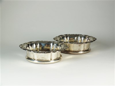 Lot 223 - A pair of George IV silver mounted wine coasters