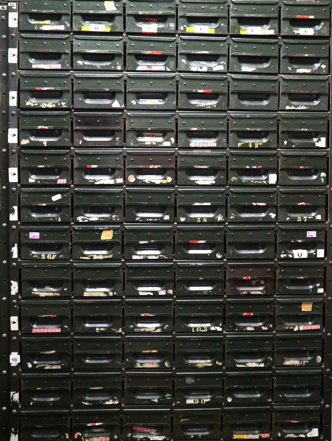 Lot 855 - A vintage 20th century bank of 107 industrial / utility painted steel storage drawers
