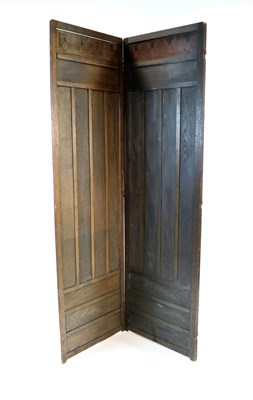 Lot 436 - An oak Arts and Crafts three fold oak dressing screen attributed to Liberty & Co