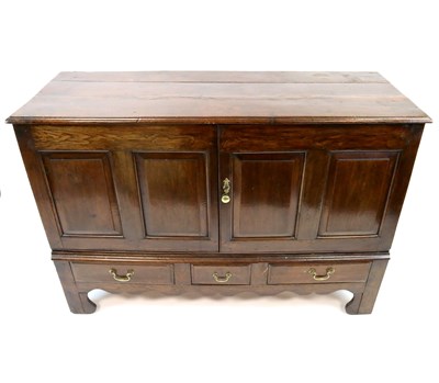 Lot 918 - A large George III panelled oak sideboard