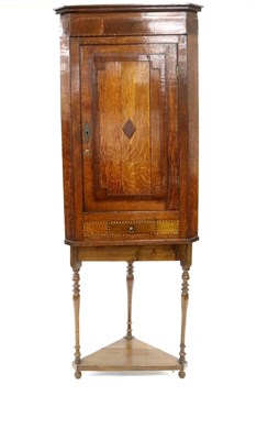 Lot 784 - A George III oak corner cupboard on an associated oak stand