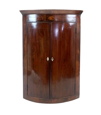 Lot 959 - A George III mahogany barrel fronted corner cupboard