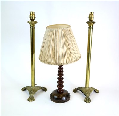 Lot 372 - A pair of polished brass table lamps and a turned wooden lamp