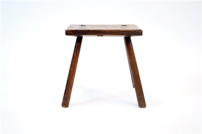 Lot 586 - An old English oak milking stool