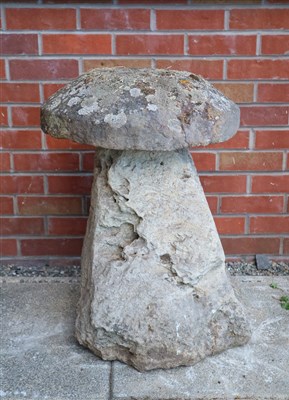 Lot 780 - An antique cut weathered limestone staddle stone and cap