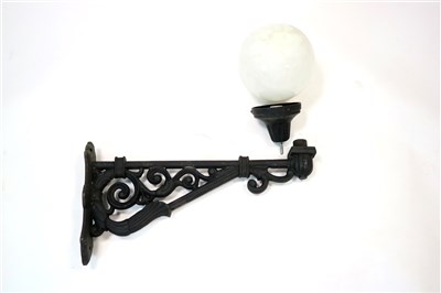 Lot 623 - A set of four painted cast iron wall lamp brackets