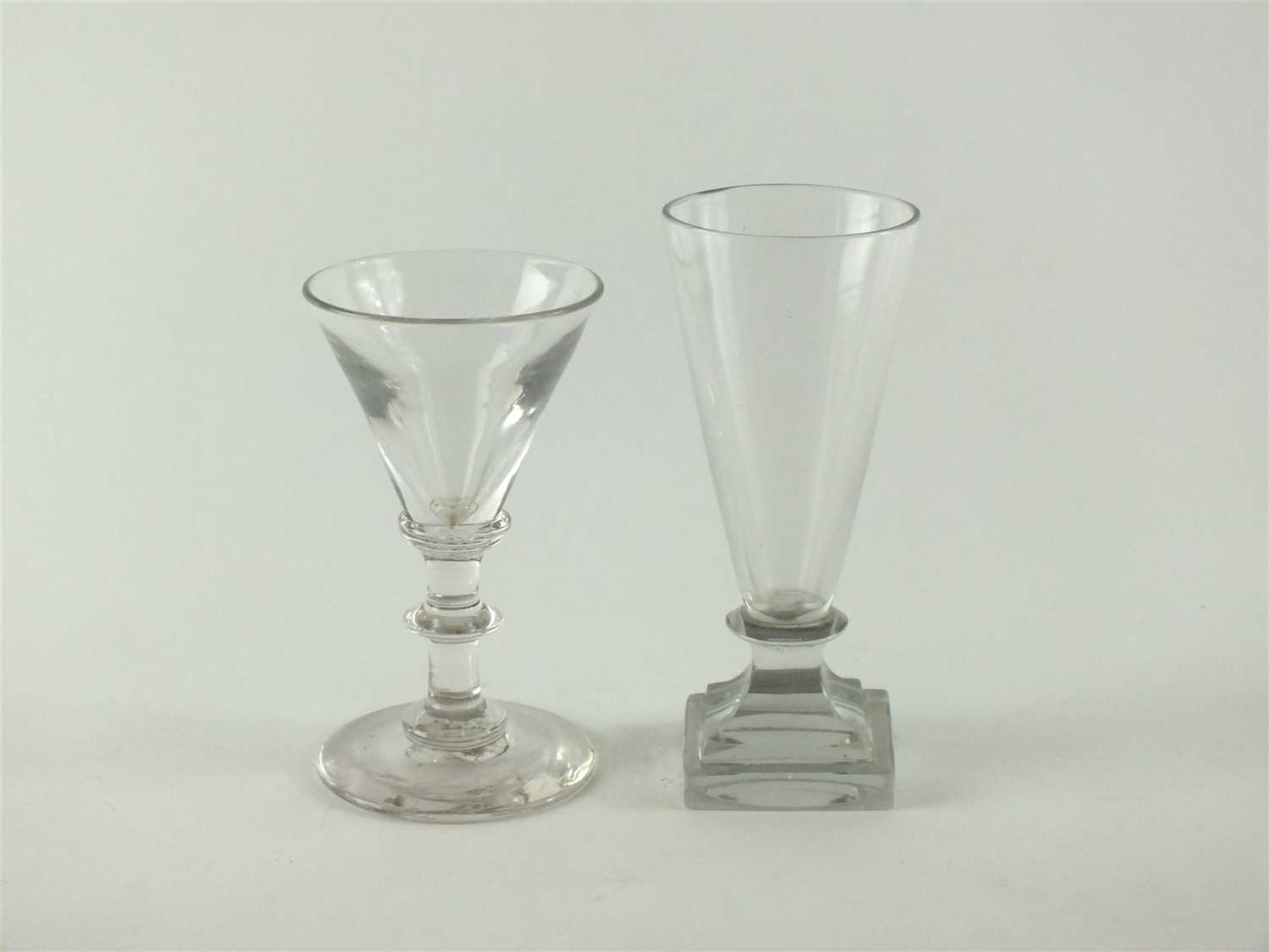 Lot 133 - An unusual 18th century dwarf ale firing glass and a 19th century wine glass