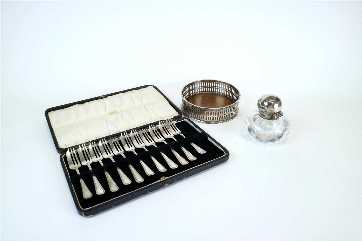 Lot 133 - A cased set of cake forks, ink well and wine coaster