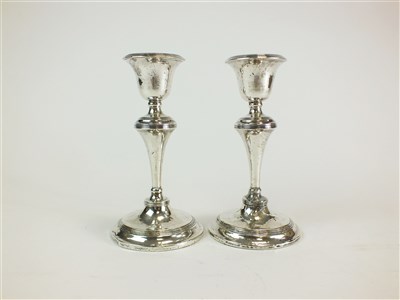 Lot 146 - A pair of silver mounted candlesticks