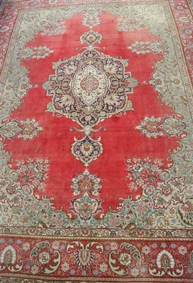 Lot 587 - A large Eastern woven wool rug