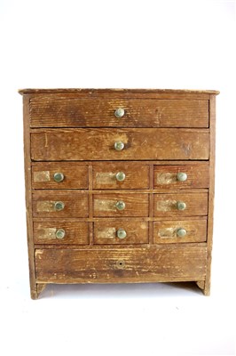 Lot 452 - A small early 20th century pine collector's bank of twelve drawers