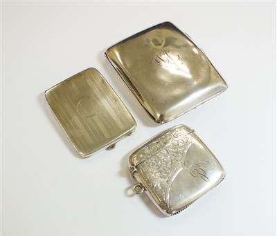 Lot 70 - A silver cigarette case and two vesta cases