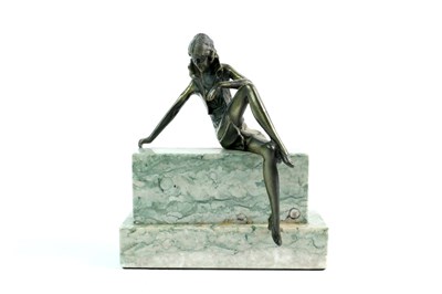 Lot 183 - An Art Deco style cast metal figure on a stepped polished marble base