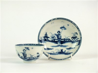Lot 13 - A Caughley porcelain 'Girl with Parasol' tea bowl and saucer