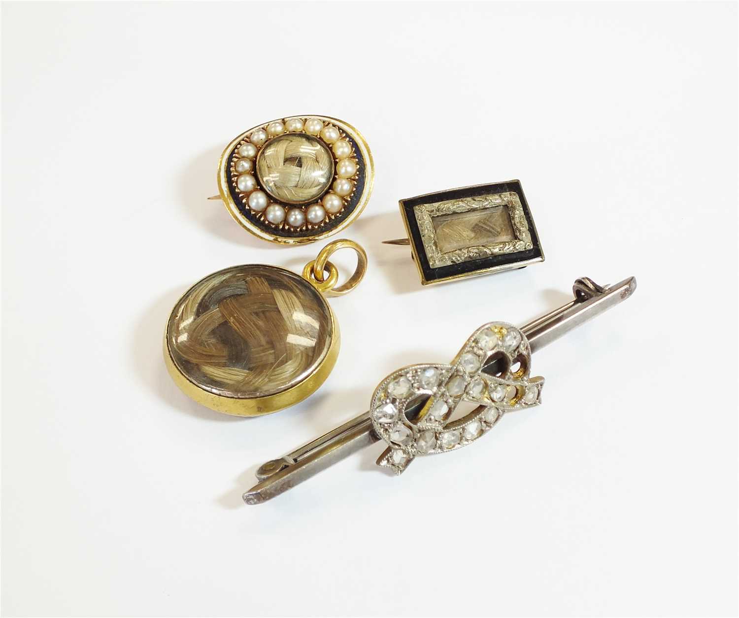 Lot 36 - Three brooches and a locket