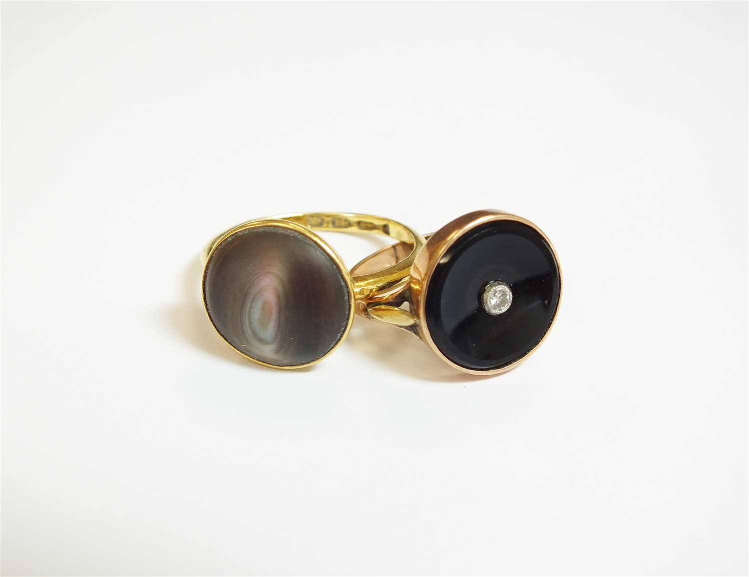 Lot 25 - An abalone shell ring and an onyx ring
