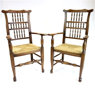 Lot 750 - A pair of oak spindle back rush-seated kitchen chairs