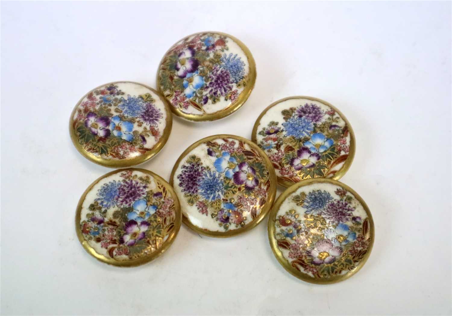 Lot 344 - A set of six Japanese Satsuma earthenware buttons