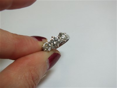 Lot 258 - An 18ct gold three stone diamond ring