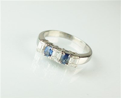 Lot 265 - A five stone diamond and sapphire ring