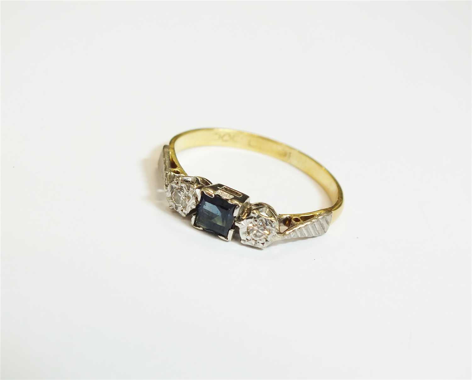 Lot 28 - A three stone sapphire and diamond ring