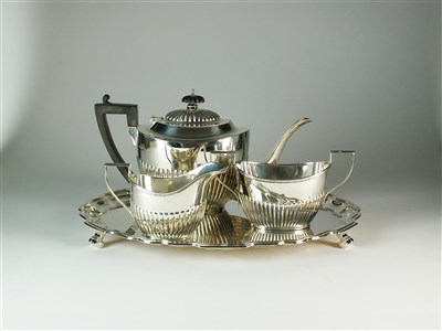 Lot 188 - A three piece silver tea service and a silver tray