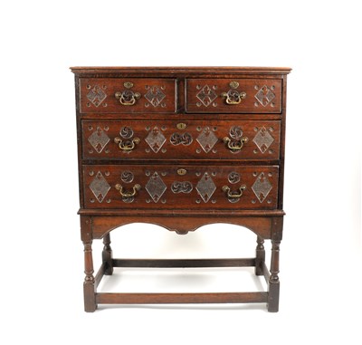 Lot 697 - An later carved George III country oak chest on stand