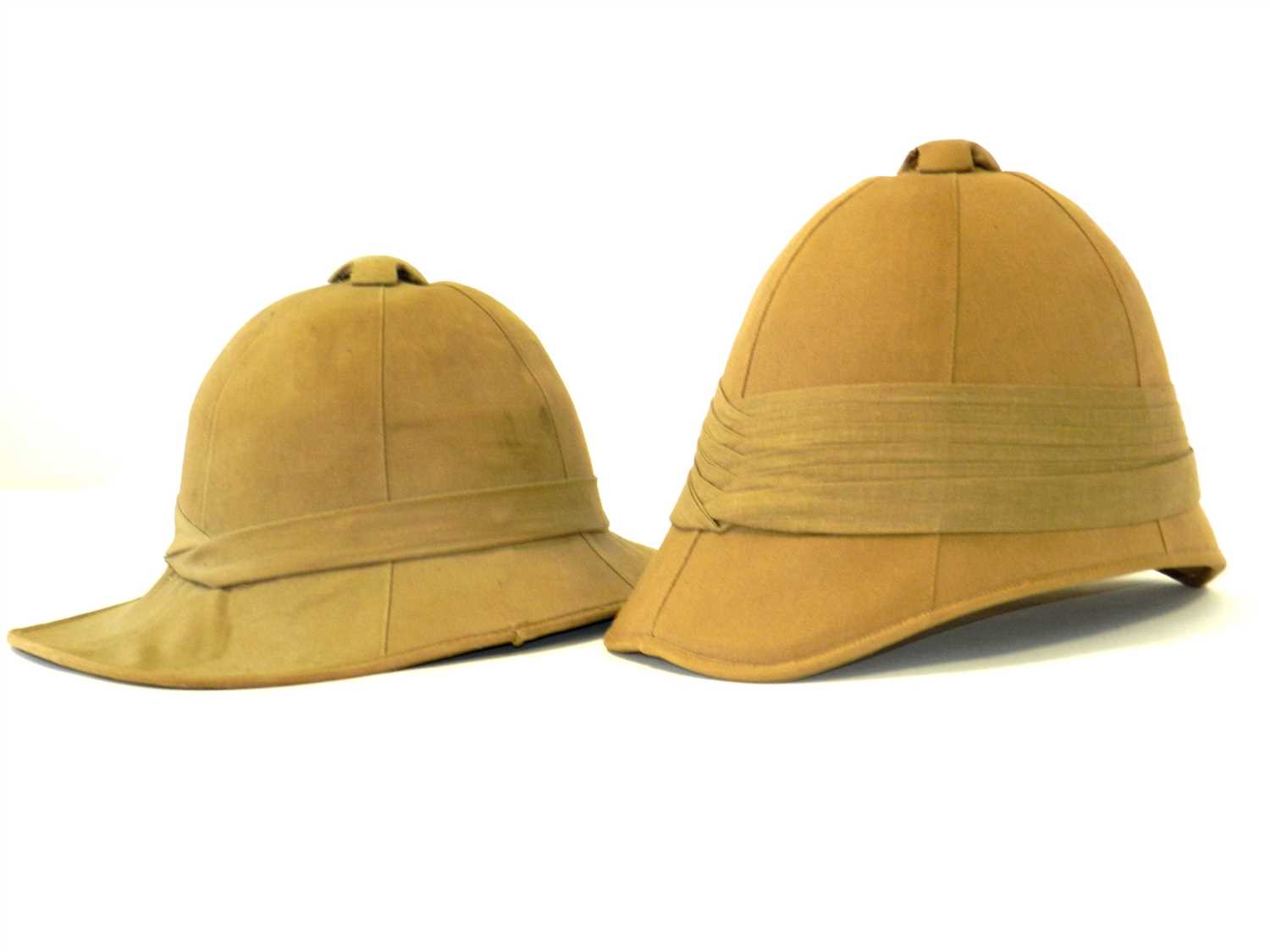 Lot 472 - Two khaki pith helmets