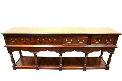 Lot 561 - A large good quality reproduction oak sideboard in the George III manner