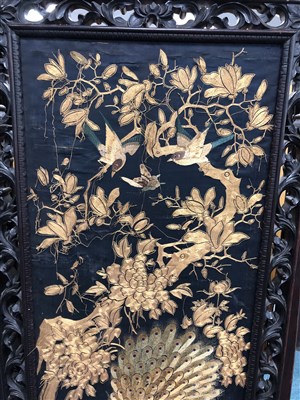 Lot 565 - A large 19th century Chinese carved hardwood four-fold screen with inset upholstered panels