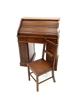 Lot 575 - A child's early 20th century oak roll-top desk and an associated oak chair