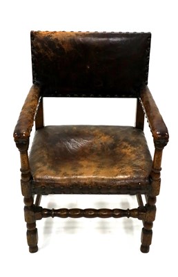 Lot 460 - An oak framed armchair, covered in studded...