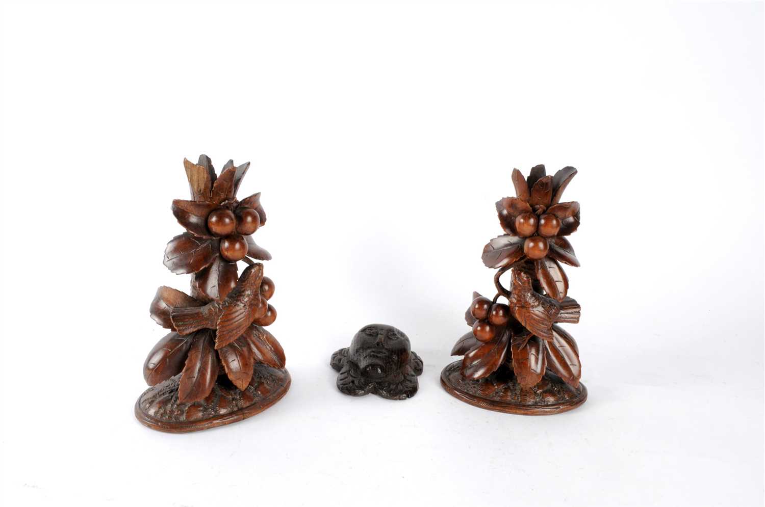 Lot 566 - A pair of 19th century Black Forest carved wooden spill vases and an oak roundel