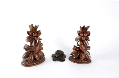 Lot 566 - A pair of 19th century Black Forest carved wooden spill vases and an oak roundel